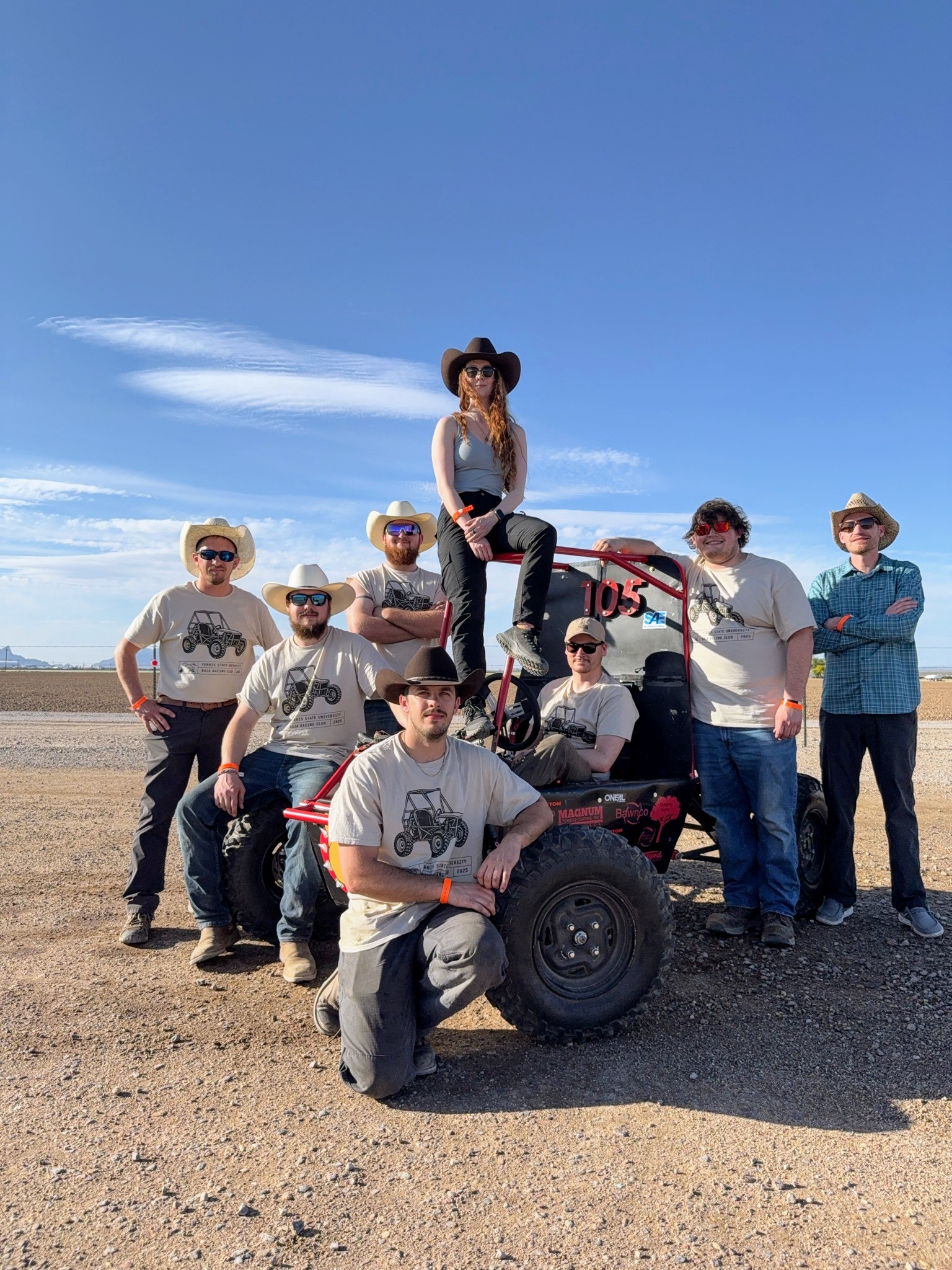 Baja race team with car in desert of Marna Arizona
