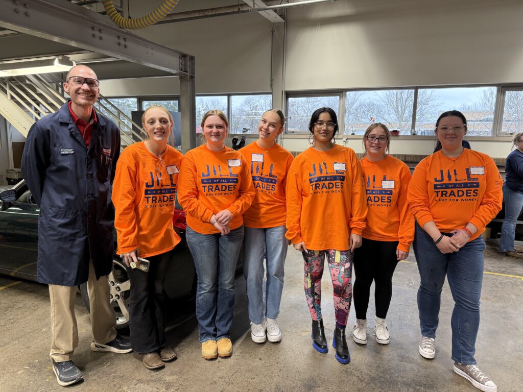 Groups of female students with professor wearing lab coat