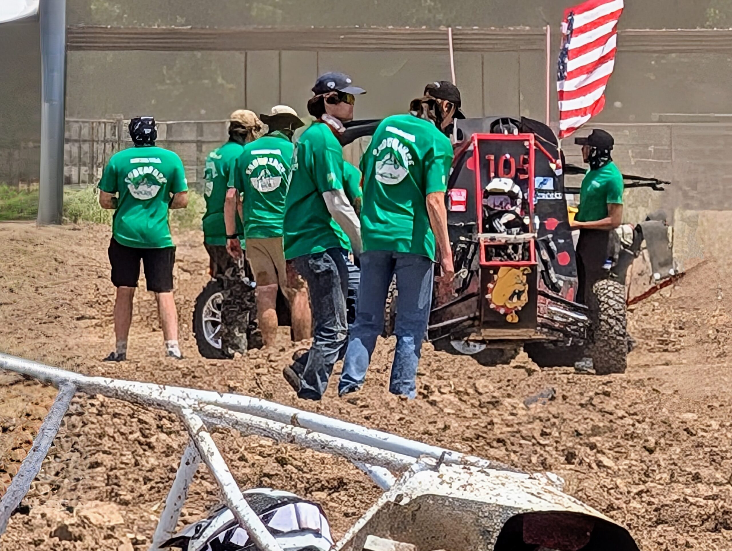 Baja Race Vehicle on track with team