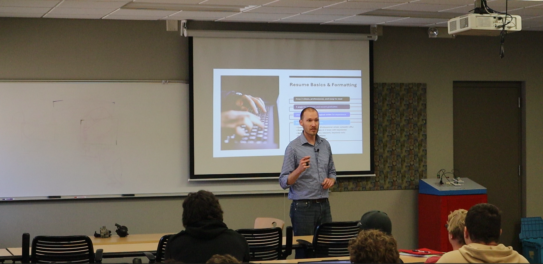 Professor Dean VanWormer in front of classroom giving a lecture to students
